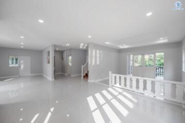 Spacious and bright empty living room with glossy tiled floors and natural light