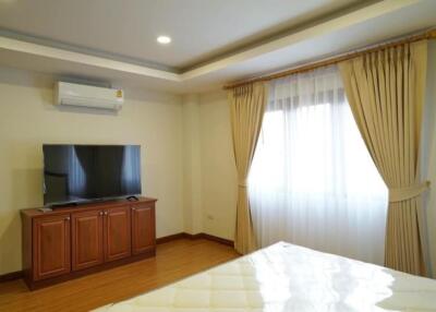 Spacious bedroom with large window and modern amenities