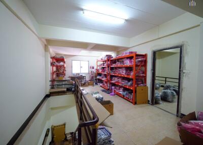 Interior of a cluttered storage room with shelves and various items