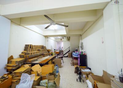 Spacious room with stacked cardboard boxes and work materials