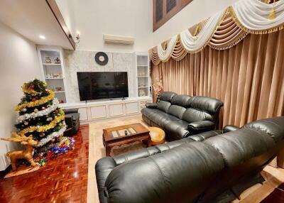 Cozy living room with Christmas tree and plush seating