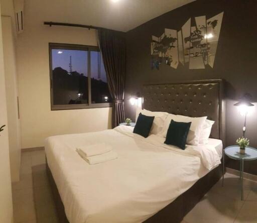 Cozy bedroom interior with king-sized bed and decorative wall art