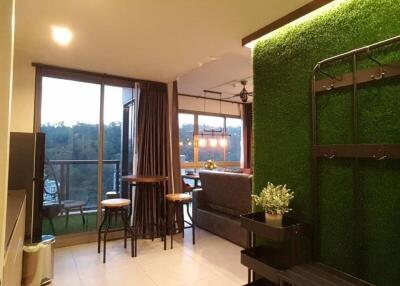 Modern living room with natural light and green wall