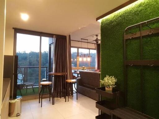 Modern living room with natural light and green wall