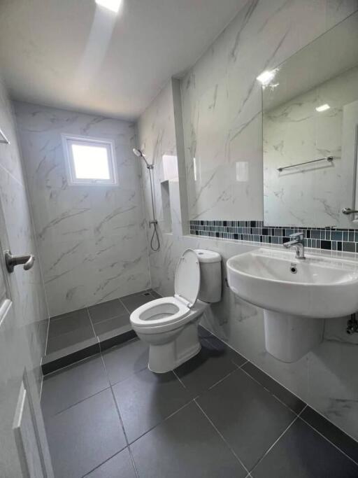 Modern bathroom with marble walls and tiled floor