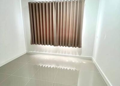 Minimalist room with tiled floor and beige curtains
