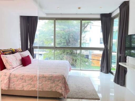 Bright bedroom with large window and modern amenities