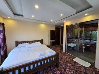 Spacious bedroom with modern lighting and access to outdoor patio