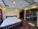 Spacious bedroom with modern lighting and access to outdoor patio