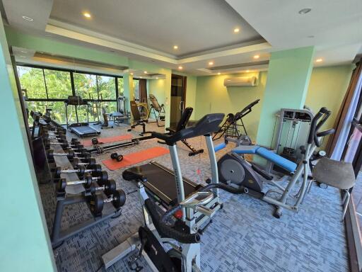 Spacious home gym with modern equipment and ample natural light