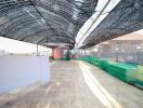 Spacious rooftop area with shade netting and safety barriers