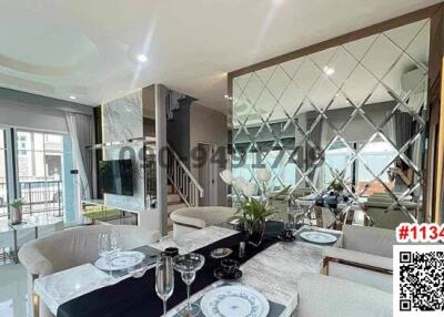Modern open-plan dining and living room with extensive mirror decor