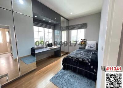 Spacious bedroom with large window and mirrored wardrobe