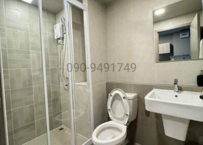 Modern bathroom interior with glass shower and ceramic fixtures