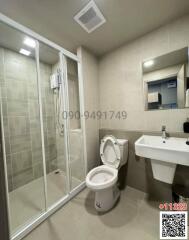 Modern bathroom interior with glass shower and ceramic fixtures