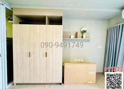 Compact bedroom interior with wooden wardrobe and packaged delivery box