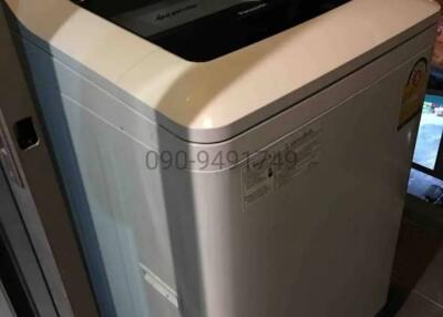 Top-loading washing machine in dimly lit room