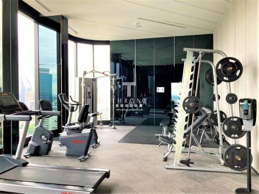 Modern home gym with exercise equipment and city view