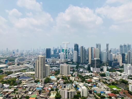 Aerial view of a dense urban cityscape with high-rise buildings under a clear sky