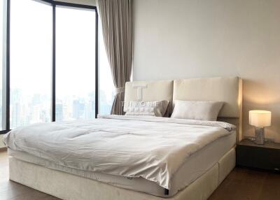 Modern bedroom with large window and city view