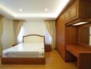 Spacious bedroom with wooden furniture and ample lighting