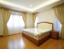 Spacious bedroom with hardwood floors and large bed