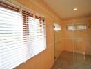 Spacious bathroom with natural light and walk-in shower