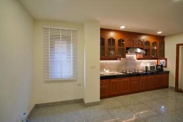 Modern kitchen with wooden cabinets and stainless steel appliances