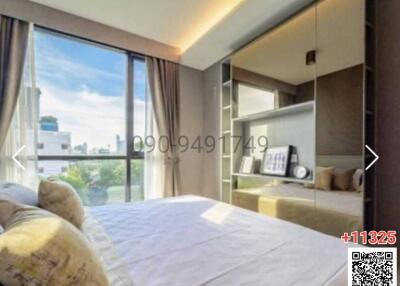 Modern furnished bedroom with large window and panoramic city view