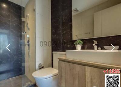Modern bathroom with marble walls and wooden cabinet