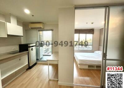 Compact and well-lit studio apartment with integrated living and bedroom space