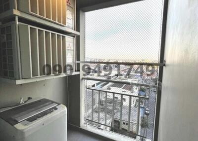 Compact laundry room with washing machine and storage units