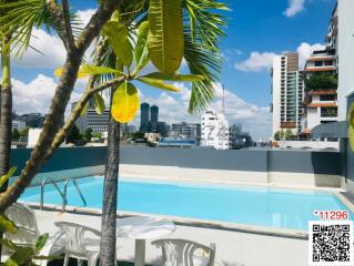 Residential building with a swimming pool and a city skyline view