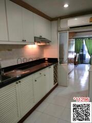 Modern kitchen with white cabinets and granite countertop