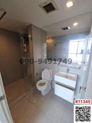 Modern white bathroom interior with glass shower and window