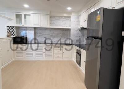 Modern kitchen with white cabinetry and stainless steel appliances