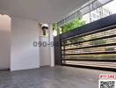 Spacious open-air patio with tiled flooring and a modern metallic fence