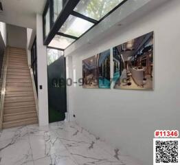 Modern hallway with staircase and decorative wall art