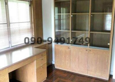 Compact bedroom with built-in wooden wardrobe and desk space