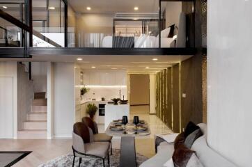 Modern open-concept building interior with a view of the kitchen, living area, and mezzanine
