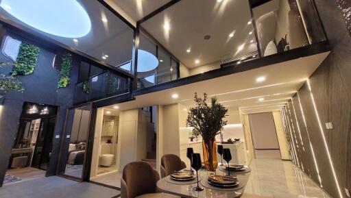 Modern interior design of spacious building with open-plan layout featuring dining area and mezzanine level