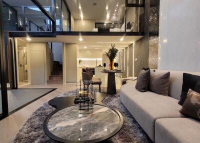 Spacious and modern open plan living room with high ceilings and luxurious finishes