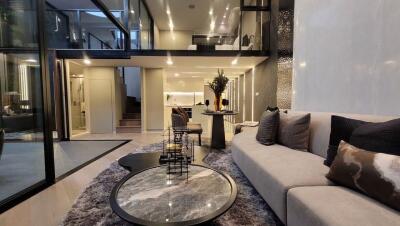 Spacious and modern open plan living room with high ceilings and luxurious finishes