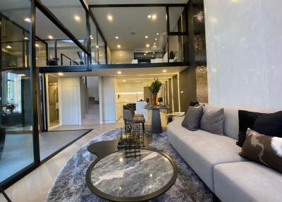 Modern open concept living room with mezzanine and stylish interior design