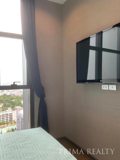 Cozy bedroom with city view and wall-mounted television