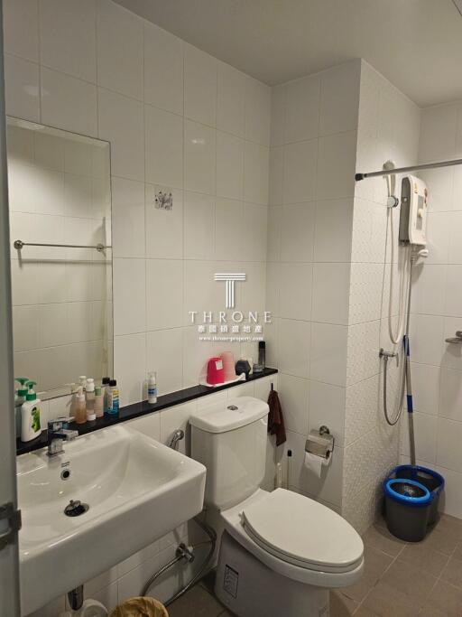 Modern bathroom with white tiles and equipped with shower and wash basin