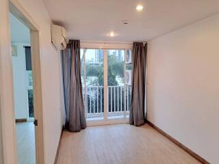 Spacious bedroom with natural lighting and balcony access