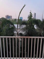 Balcony view overlooking the city skyline surrounded by greenery