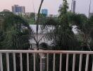 Balcony view overlooking the city skyline surrounded by greenery