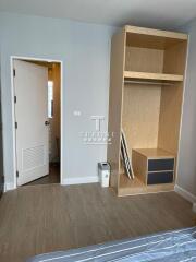 Bright bedroom with wooden built-in wardrobe and light blue walls